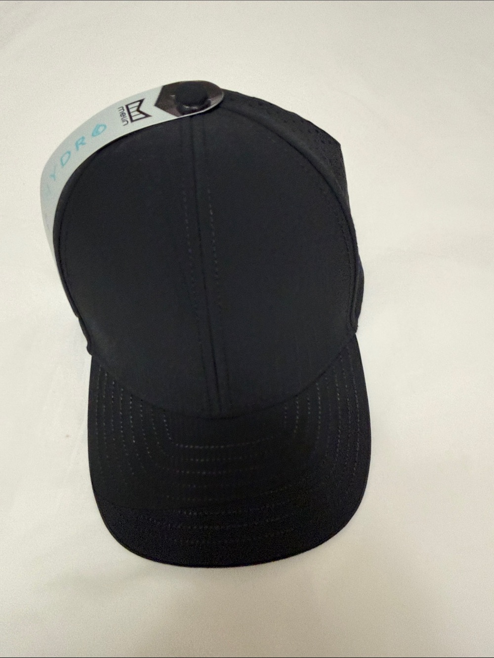 Melin Black Performance Mesh Trucker Hat